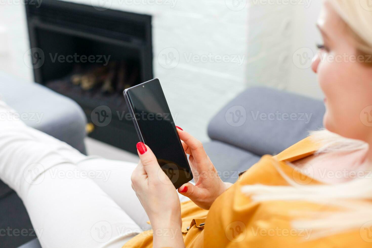 Woman at home relaxing on sofa couch reading email on the tablet computer wifi connection photo
