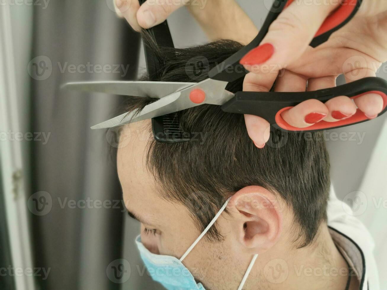 coronavirus de los hombres Corte de pelo a hogar, en línea peluquería tutoría en un ordenador portátil foto