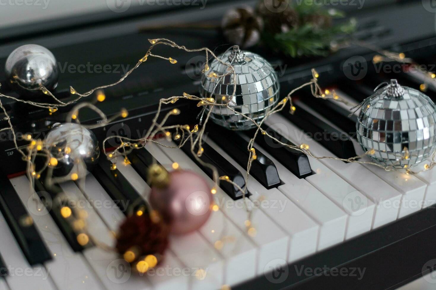 Top view close up shot of piano keyboard and Christmas decoration. photo