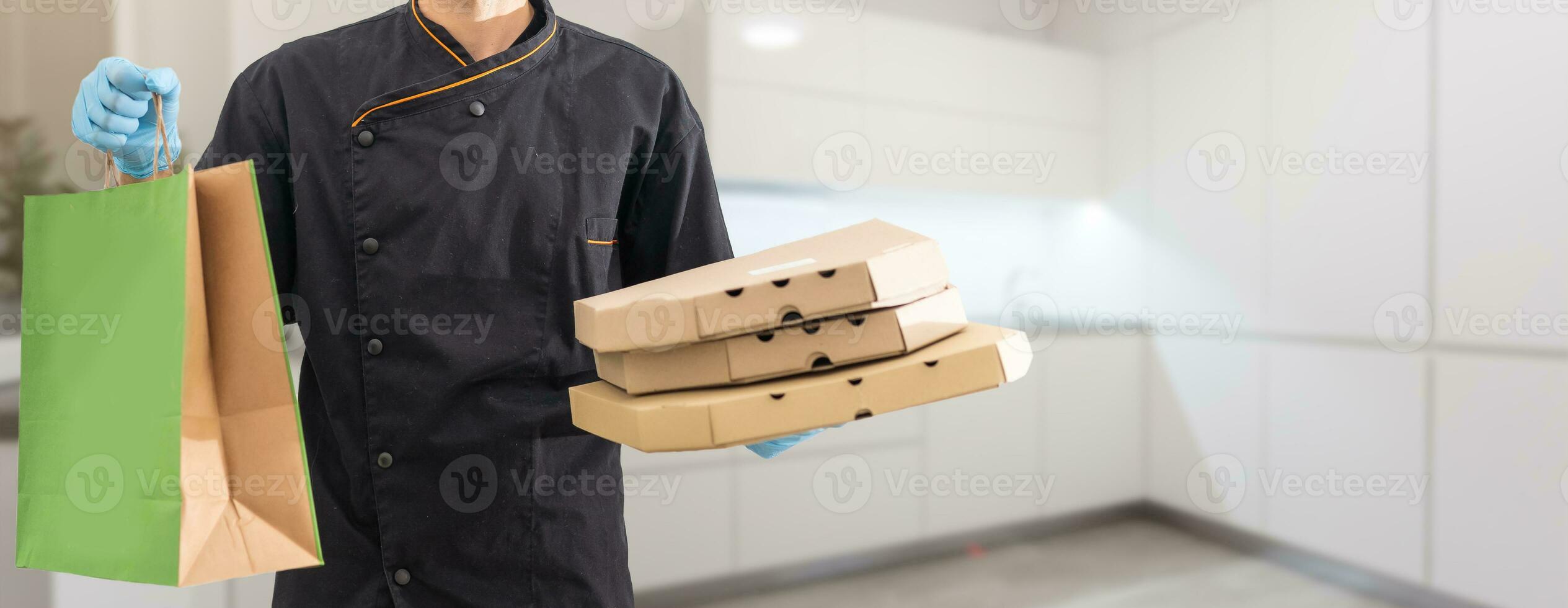 Young handsome man holding delivery paper bag photo