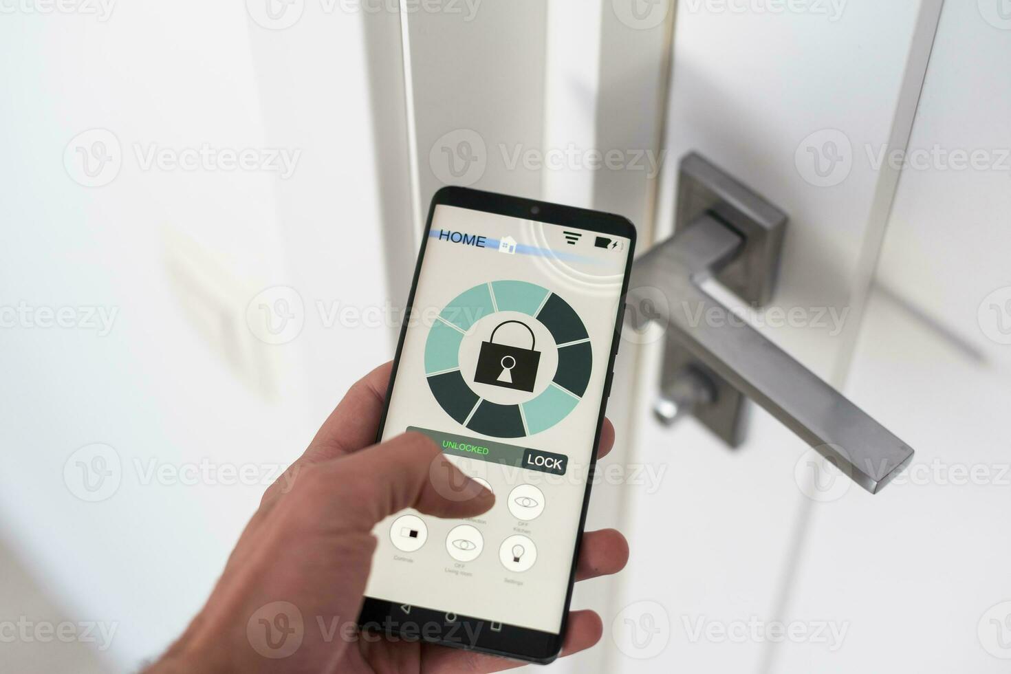 Man with mobile phone using smart home security system application photo