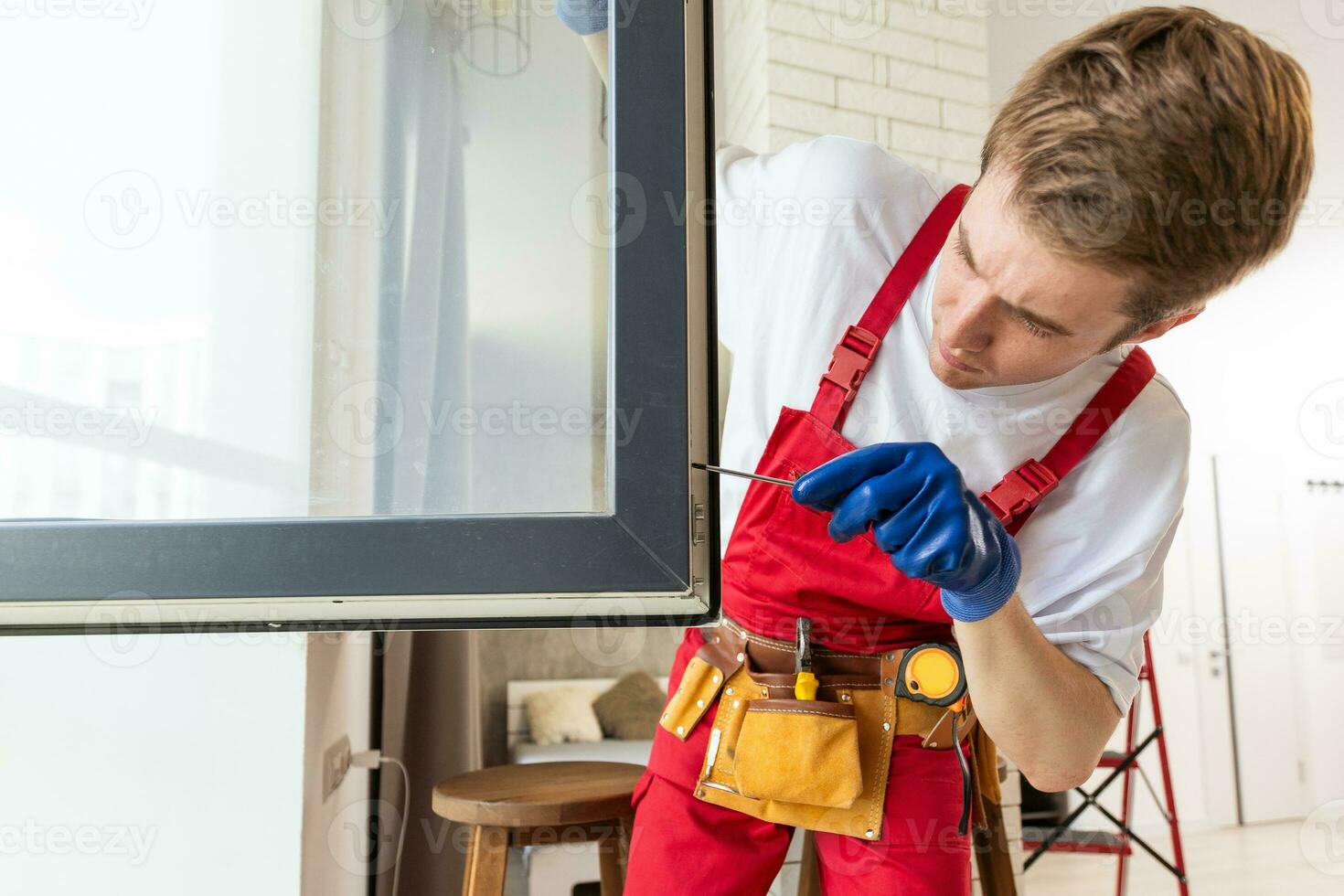 A repairman fixing windows in new apartment. photo