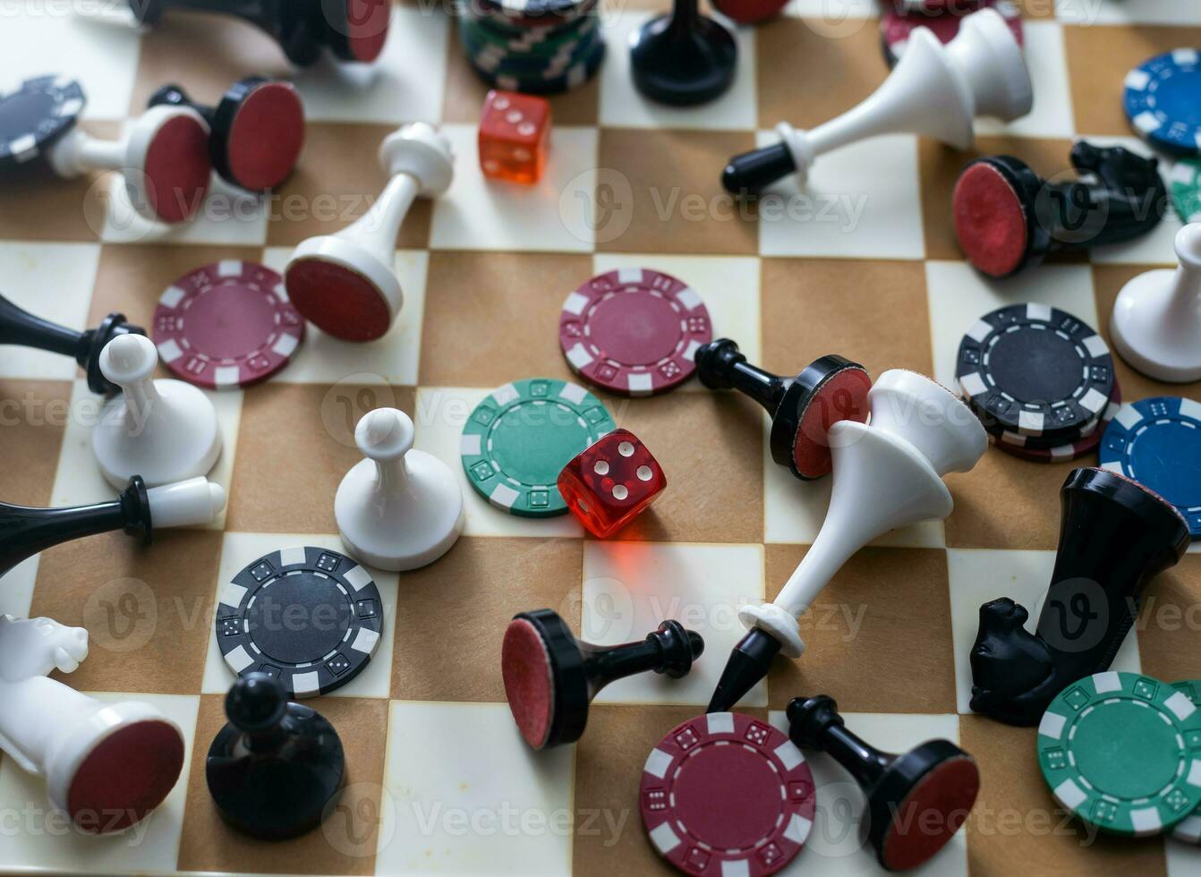 Wooden checkers, chess pieces, playing cards, board games on a light table close up. photo