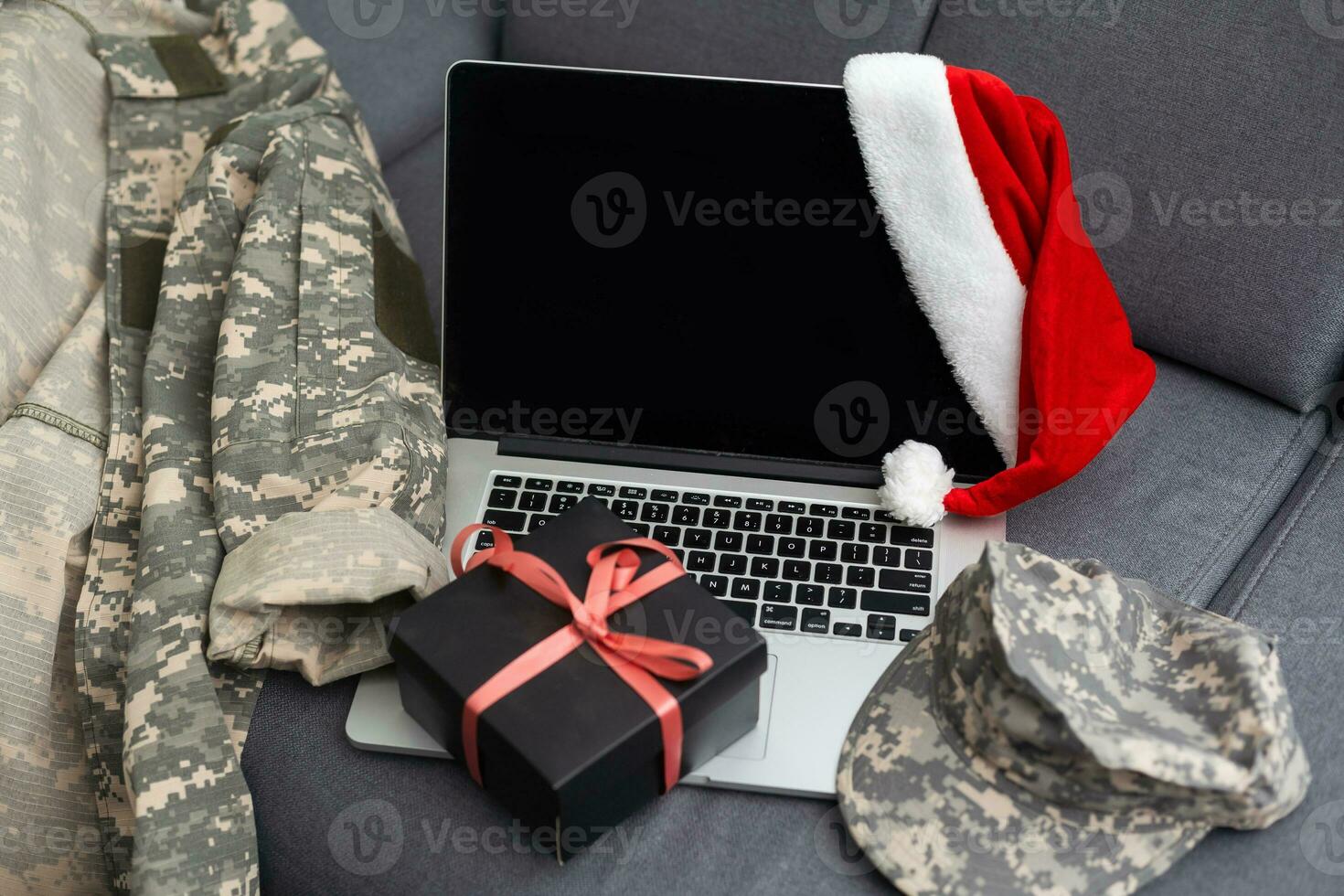 military uniform and a Santa hat with a laptop photo