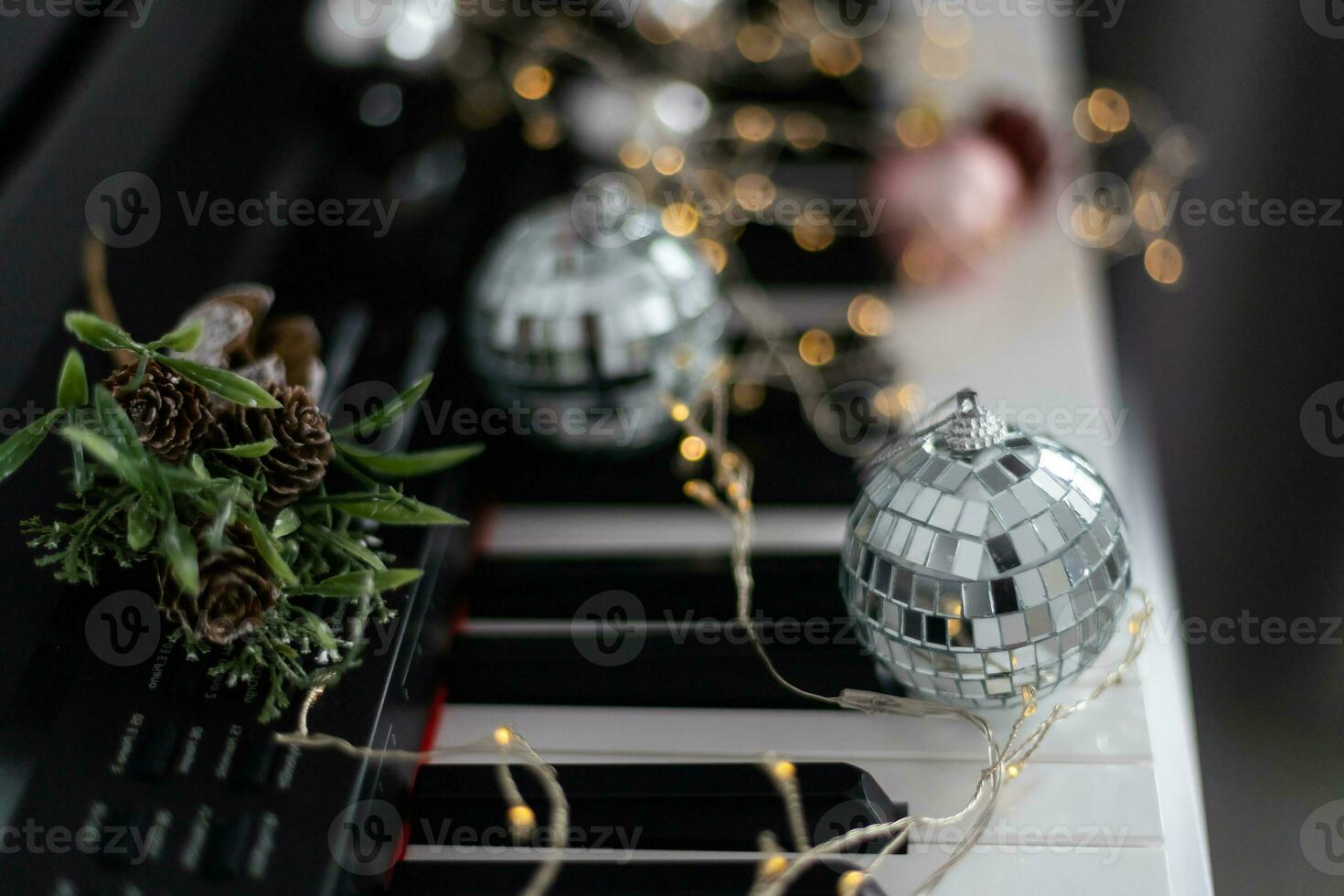 Christmas ball on piano keys. Carol music concept photo