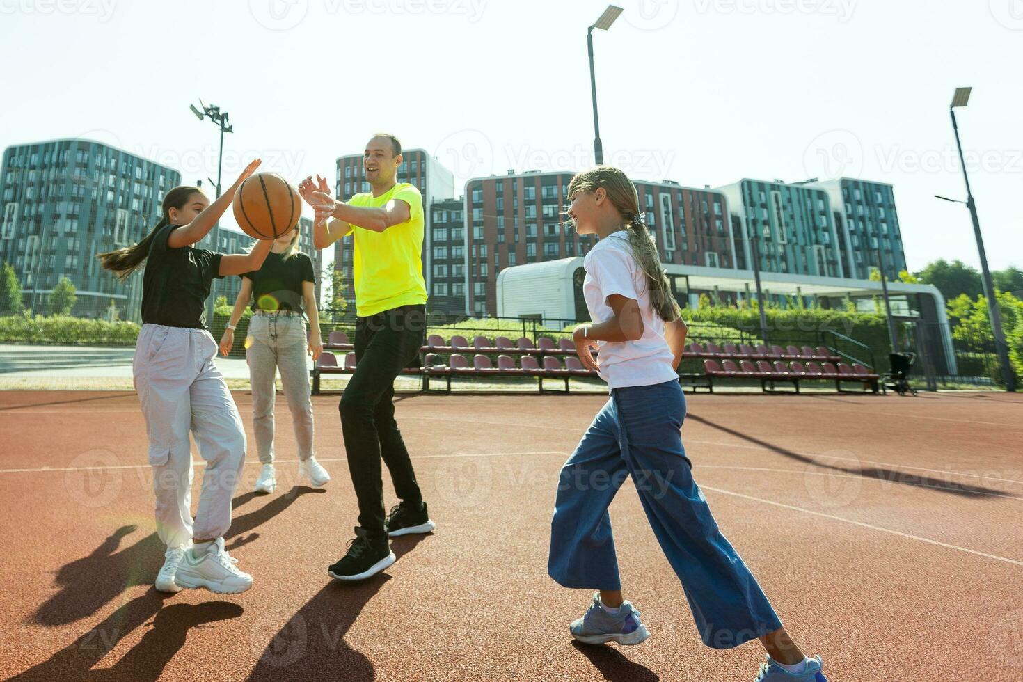 the family plays basketball on the court photo