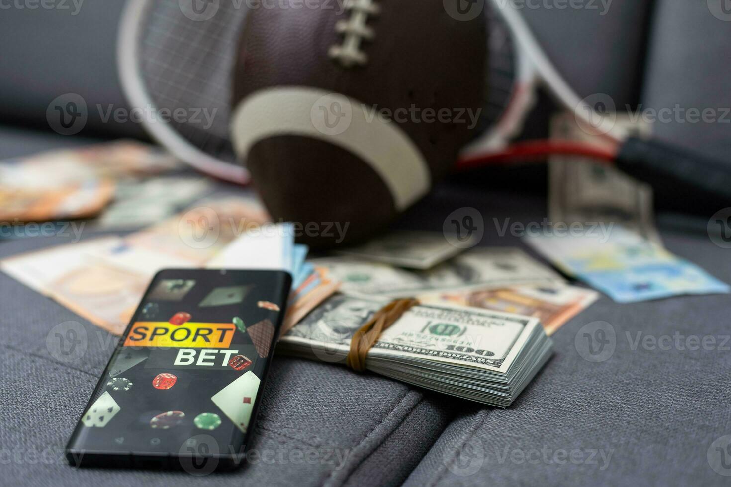 Sports betting website in a mobile phone screen, ball, money photo