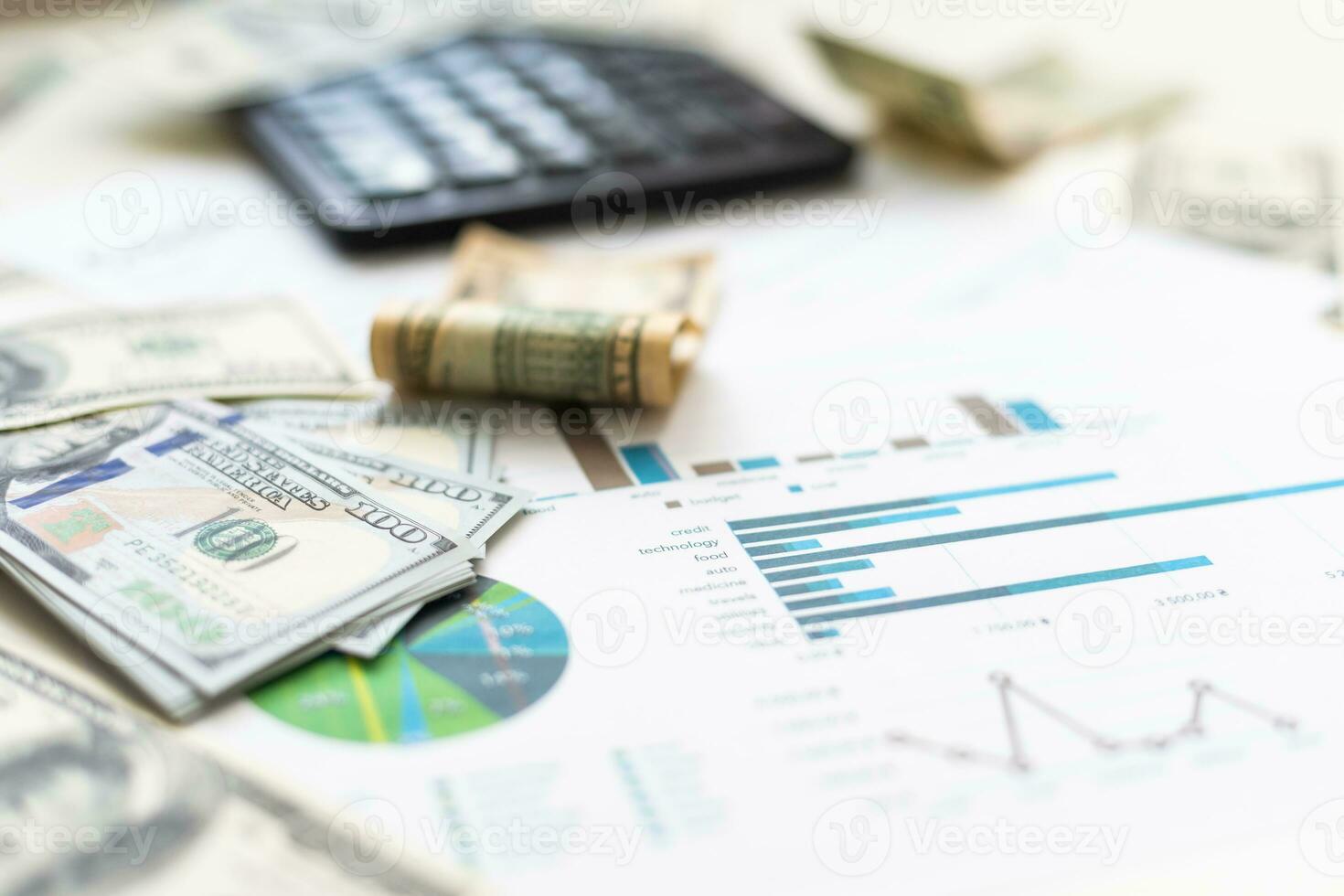 Accounting charts and graphs with us dollar bills pen calculator. Stock market graphs photo