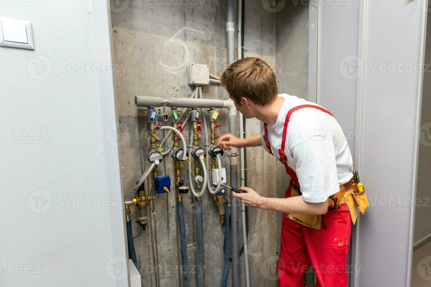 plumber installing pressure meter for house heating system photo