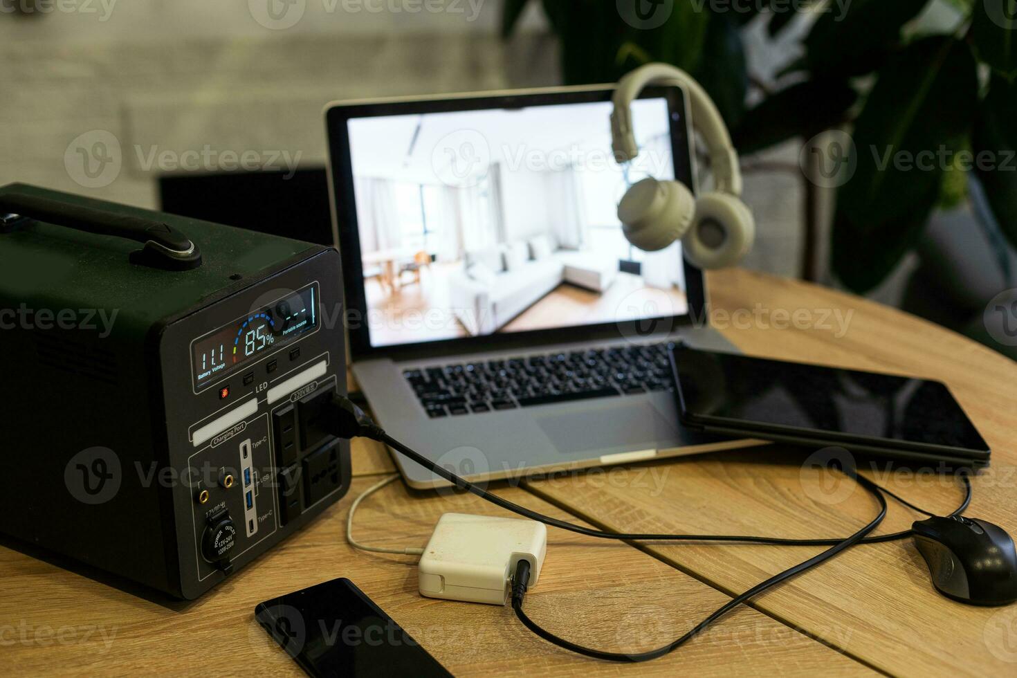 Portable power station charging devices on table in living room photo