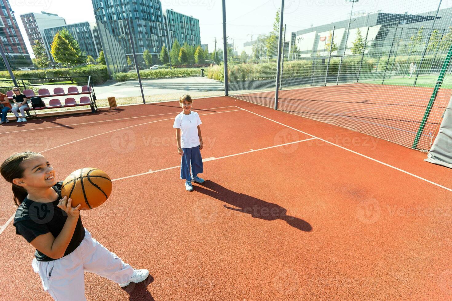 girls playing basketball on the basketball court photo