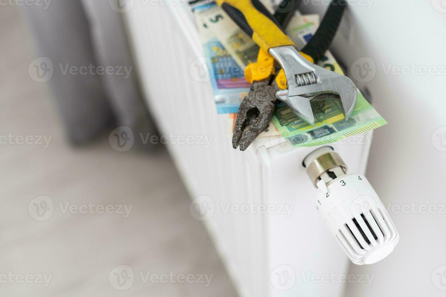 A stack of money on the background of the radiator. Expensive utilities. photo