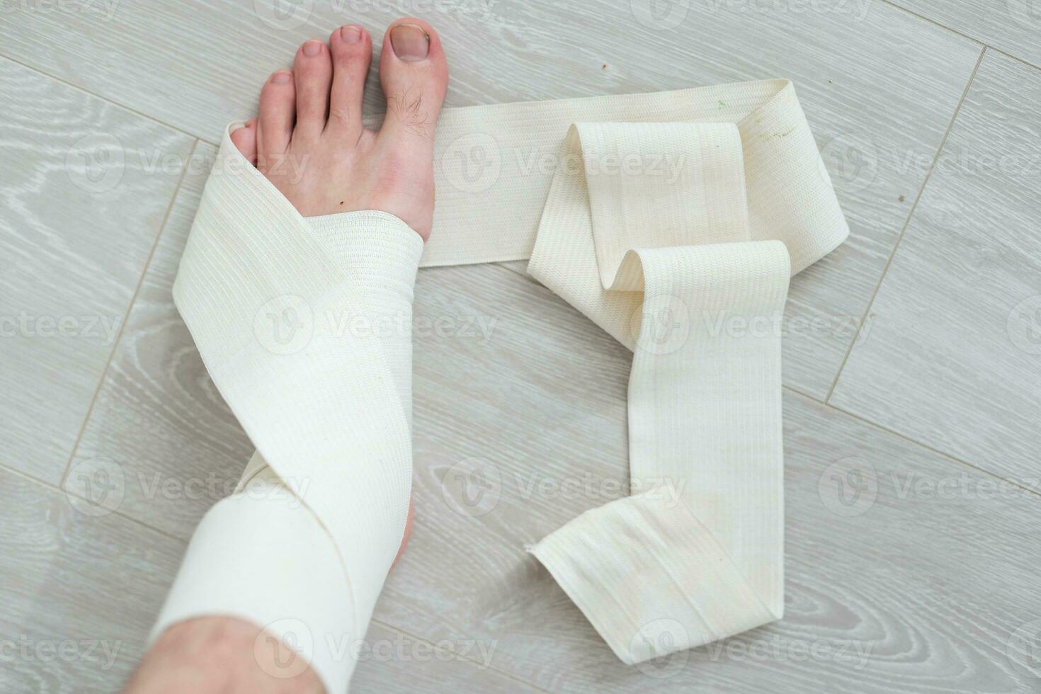 man using put on elastic bandage with legs having leg pain photo