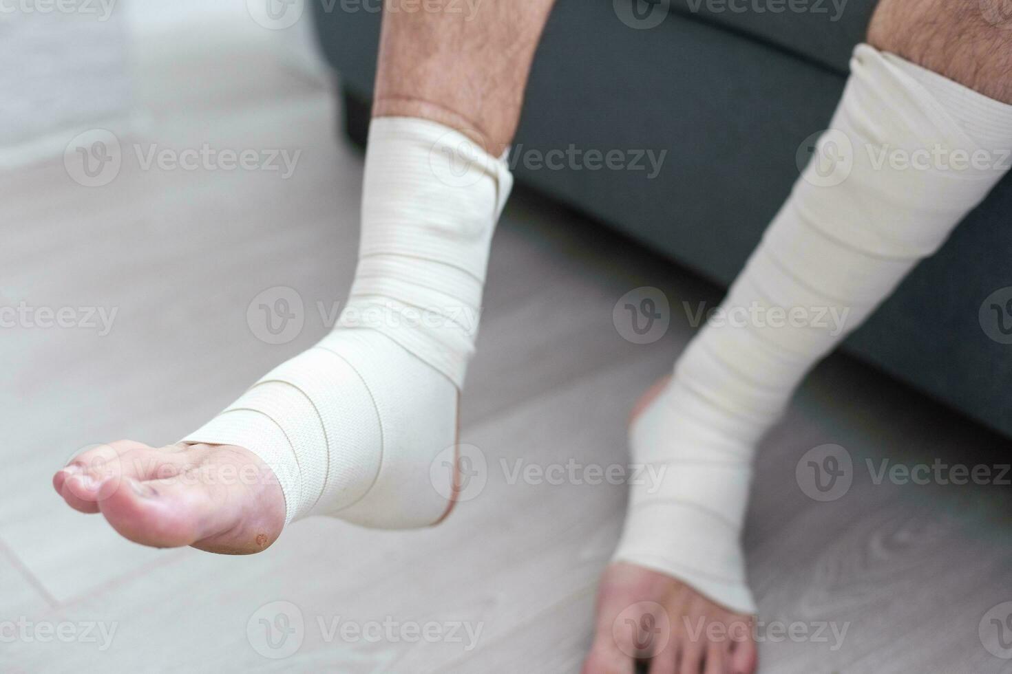 man using put on elastic bandage with legs having leg pain photo