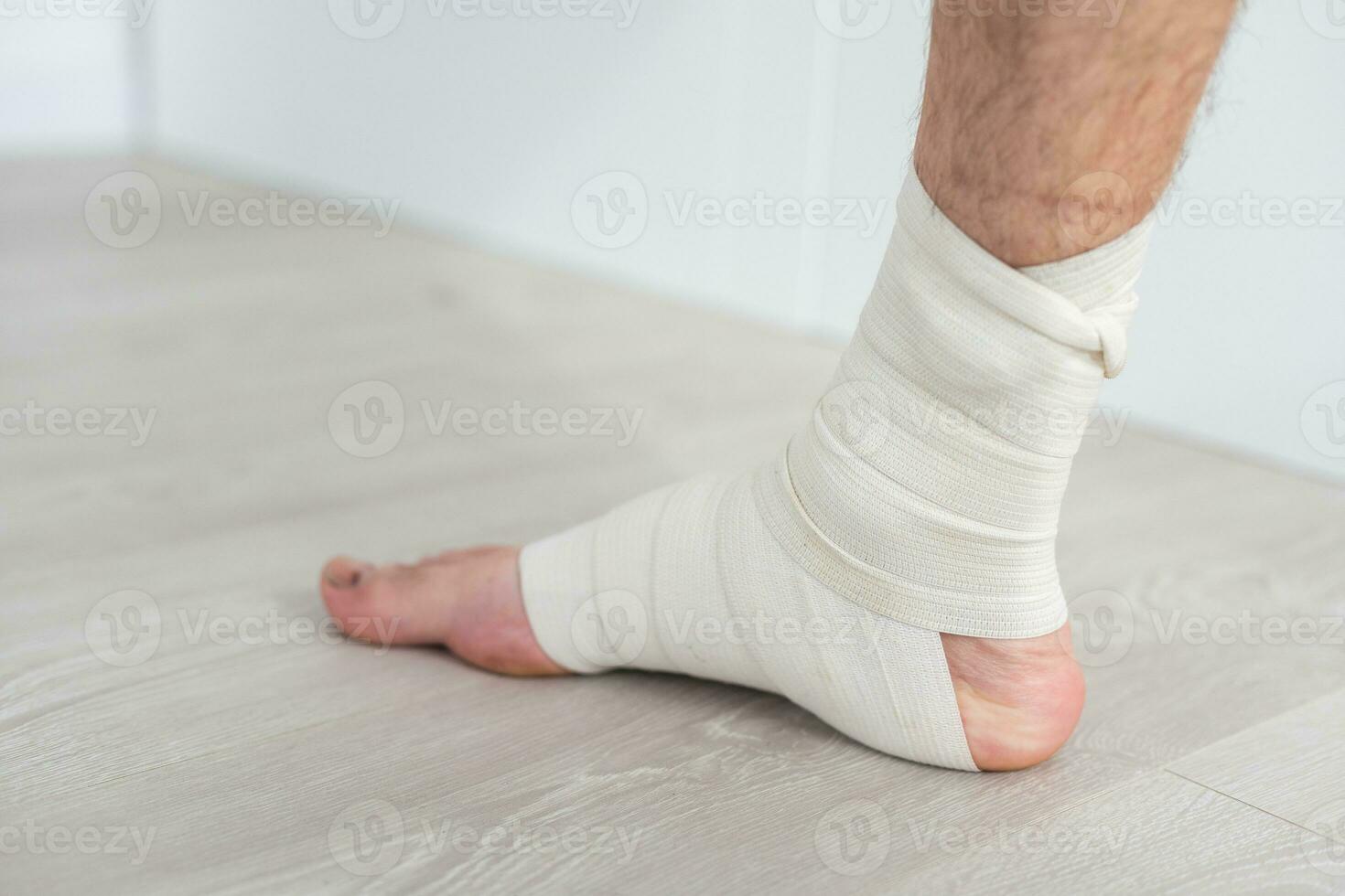 man using put on elastic bandage with legs having leg pain photo