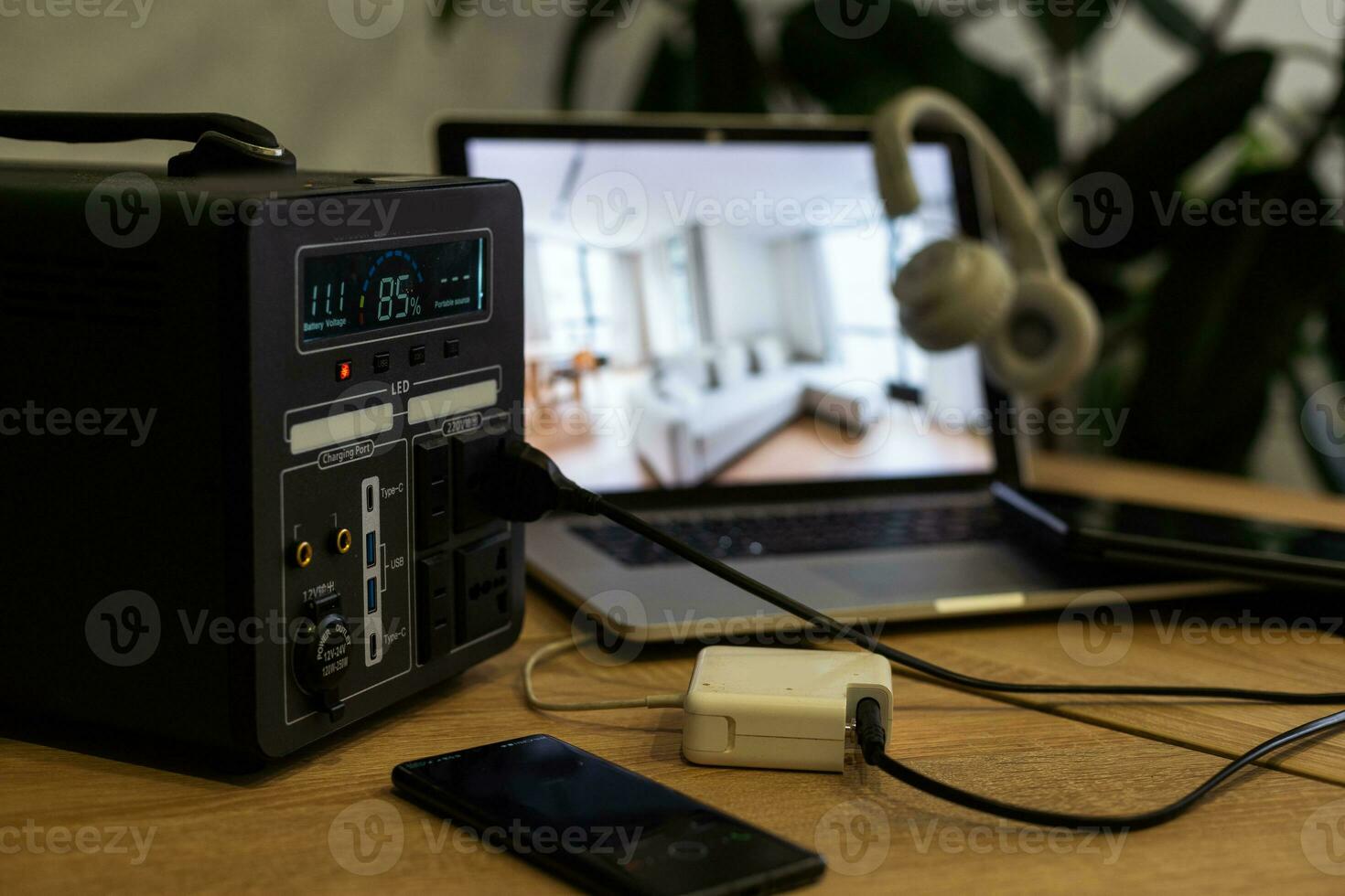 A studio desk with a PC laptop and controller on a wooden desk photo