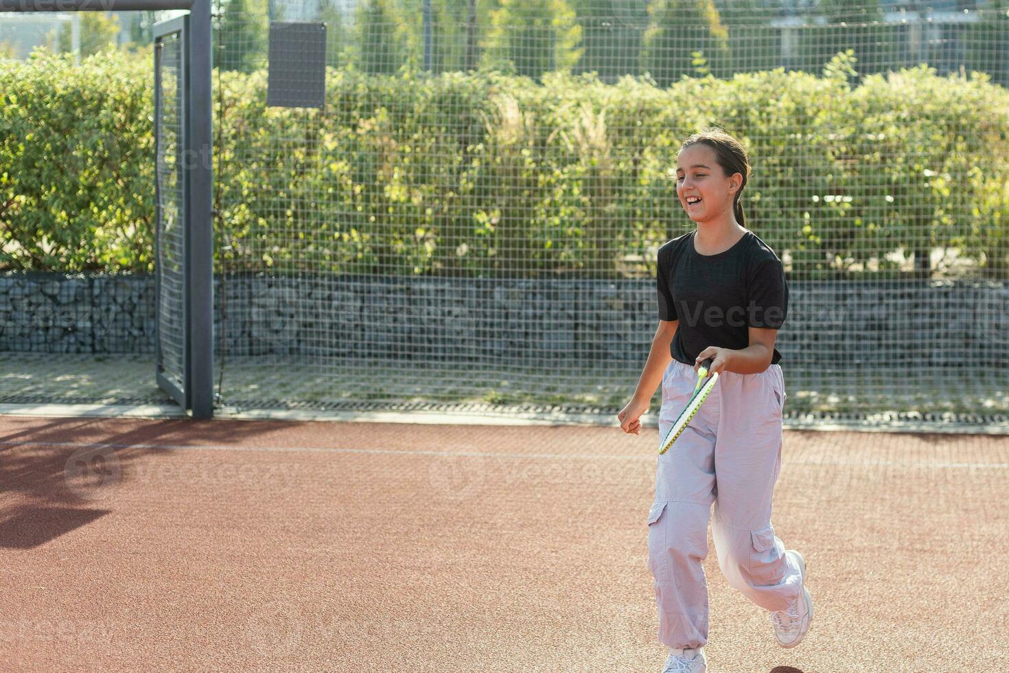 Nice girl with racket in hands playing game of tennis photo