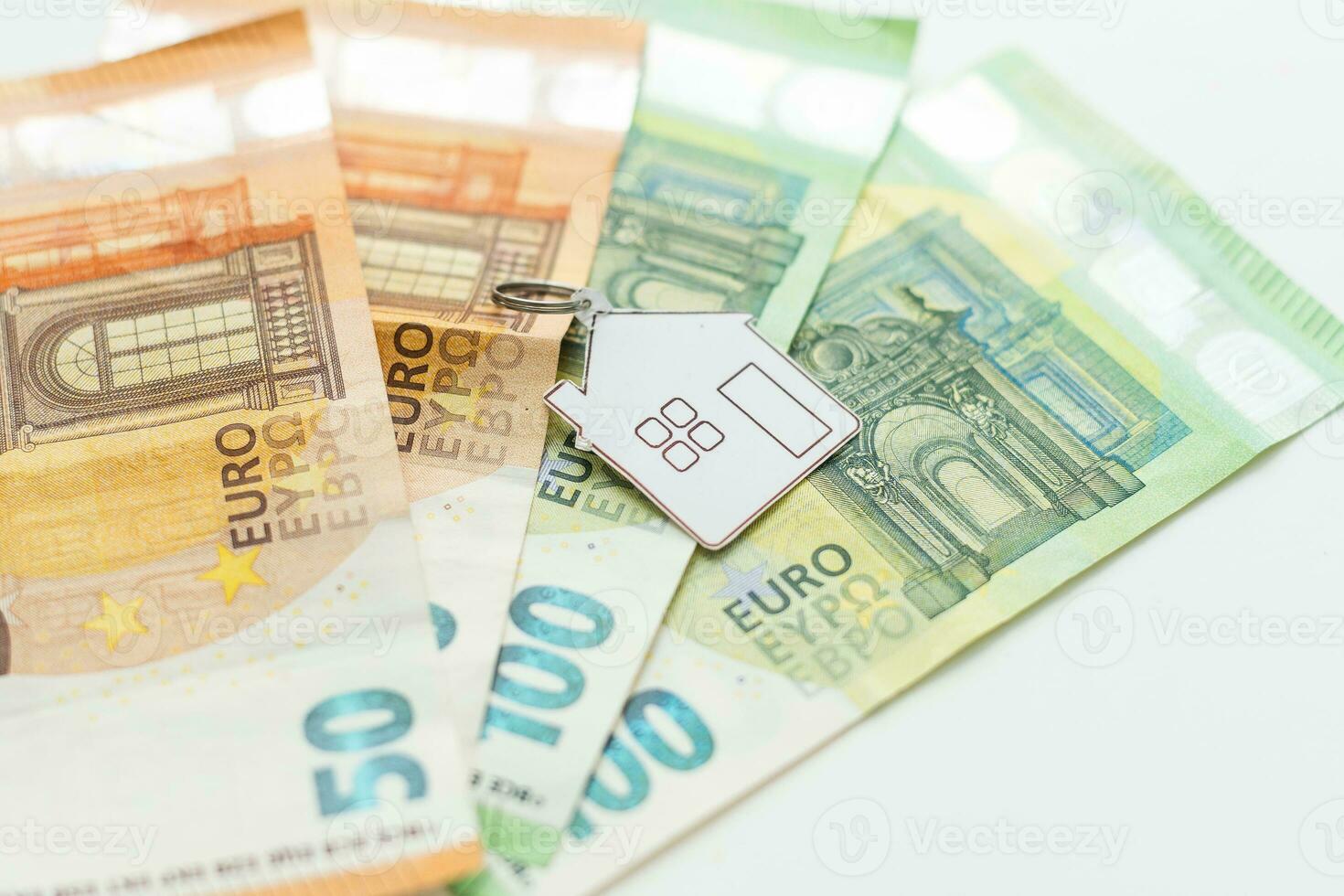Model of house with keys on euro bills. Close up. photo