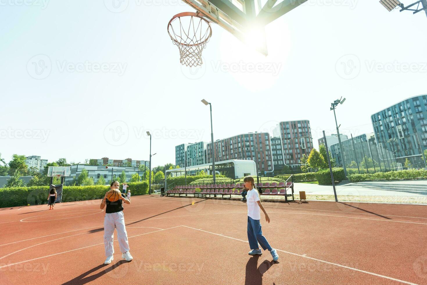 Concept of sports, hobbies and healthy lifestyle. Young people playing basketball on playground outdoors photo