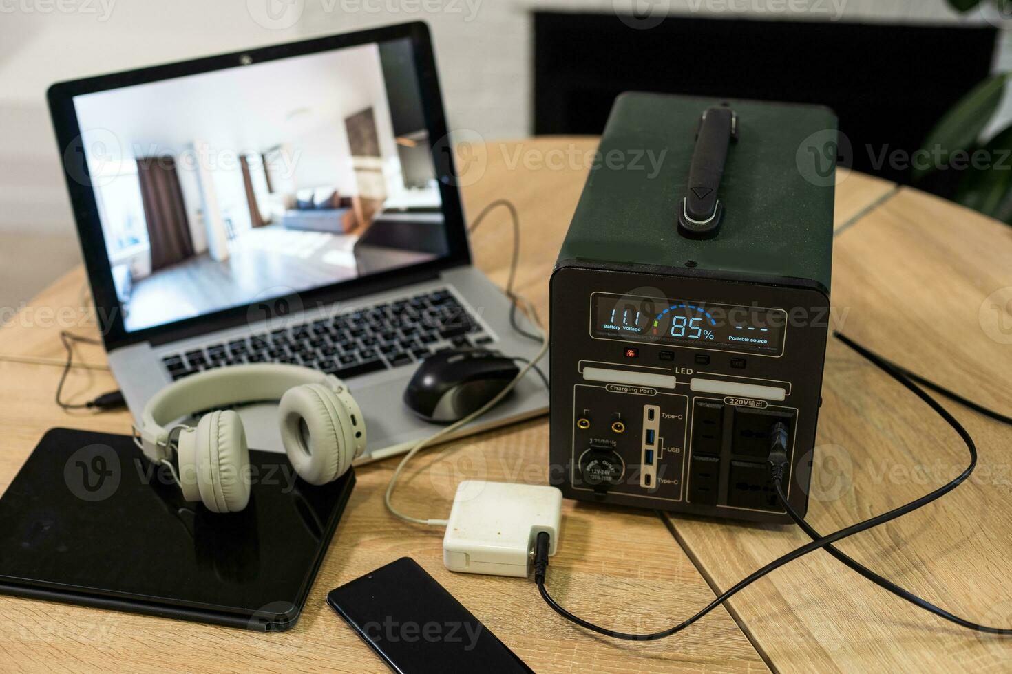 Portable power station charging devices on table in living room photo