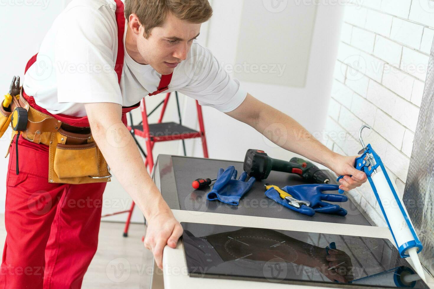 portrait of man installing kitchen hob photo