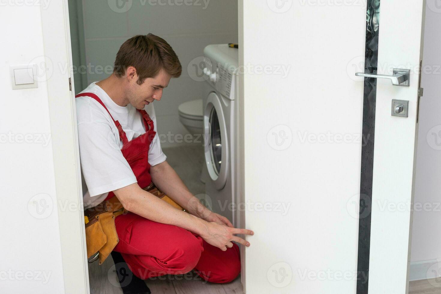 Young man fixing the door in house. photo