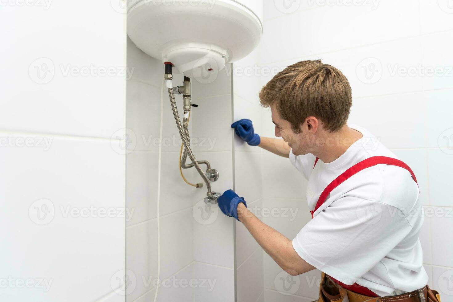 Professional engineer doing a boiler inspection at home photo