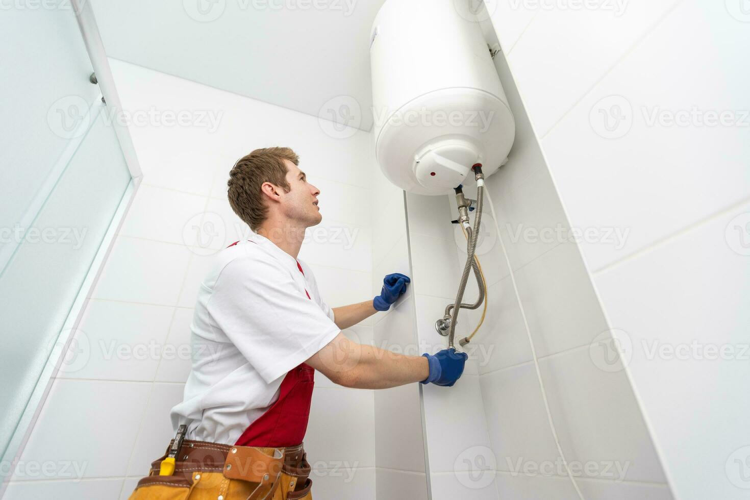 Professional plumber checking a boiler and pipes, boiler service concept. photo