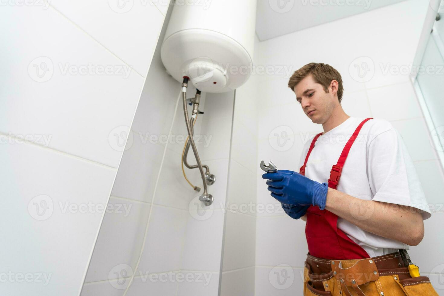 Professional engineer doing a boiler inspection at home photo