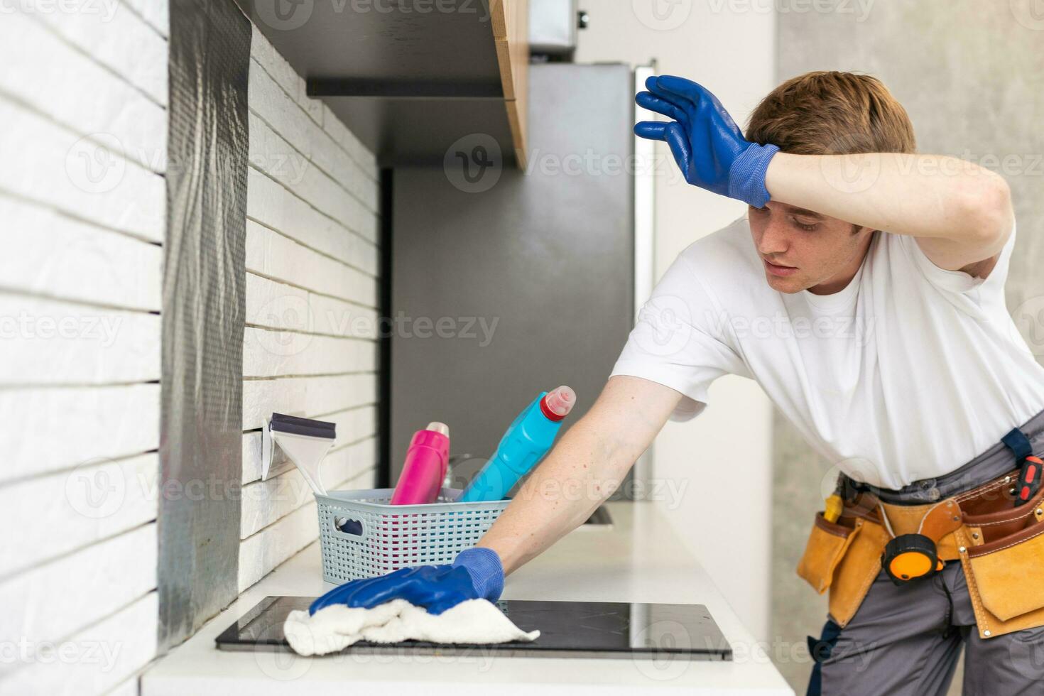 Young man is doing some cleaning work in the house photo