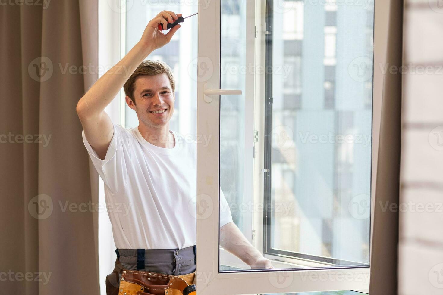 Worker installing plastic window indoors, closeup view photo