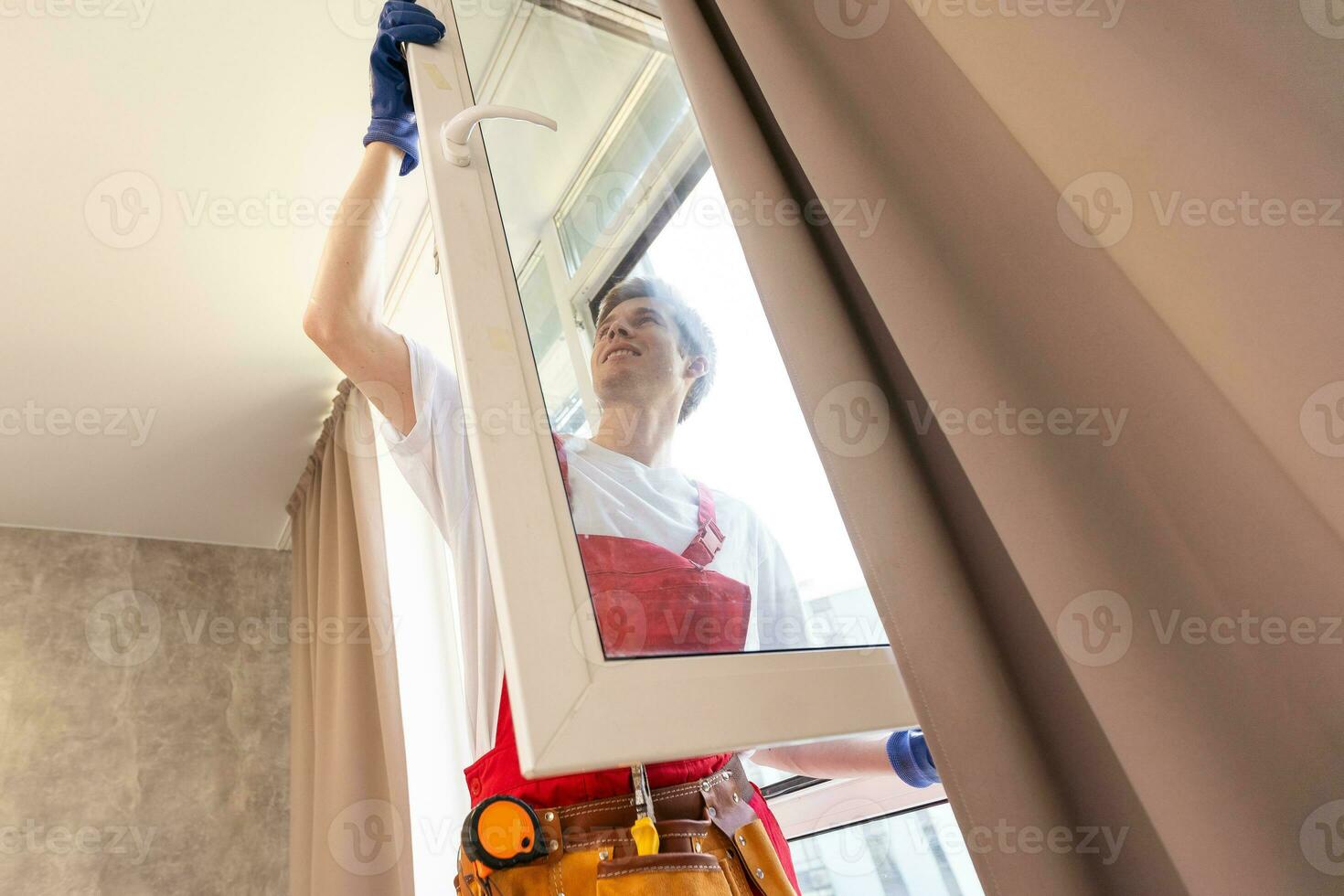 A repairman fixing windows in new apartment. photo