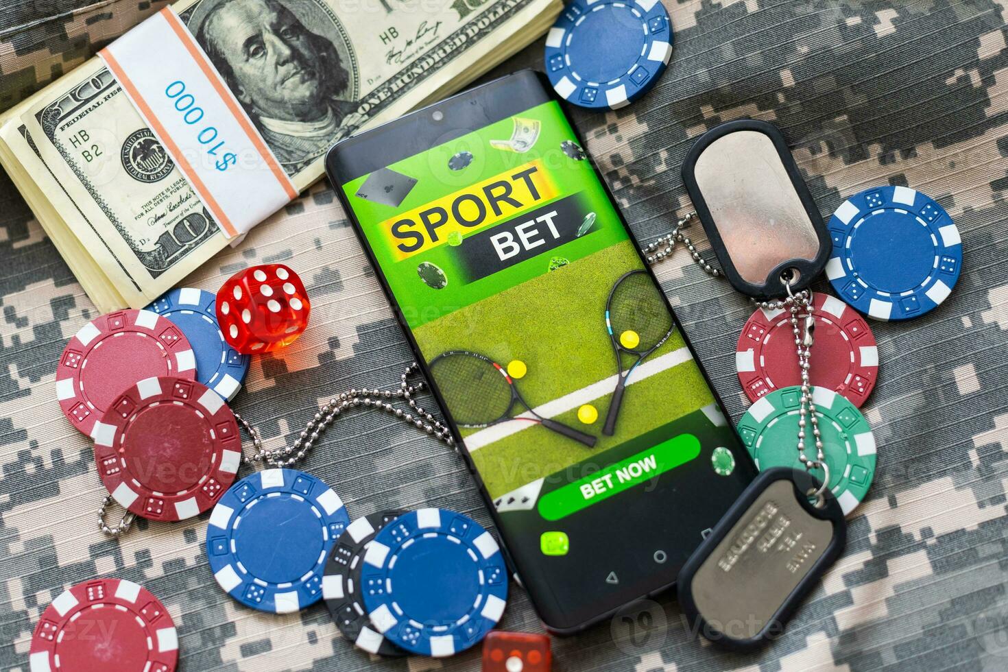 Creative background, online casino, in a man's hand a smartphone with playing cards, roulette and chips, blackgold background. Internet gambling concept. Copy space. photo