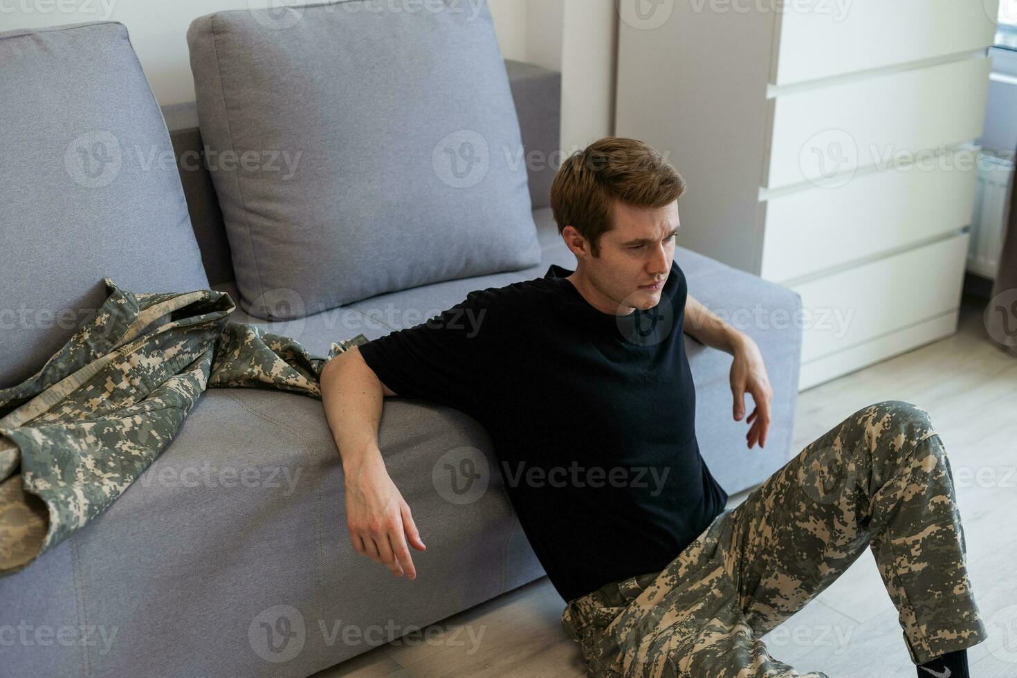 Portrait of military man being deep in thoughts feeling sorrowful photo