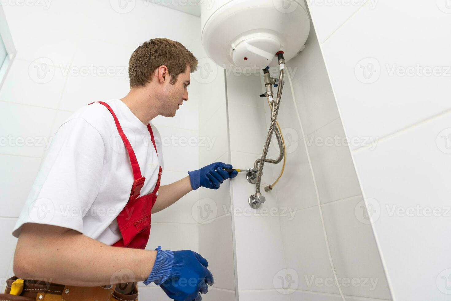 Professional engineer doing a boiler inspection at home photo