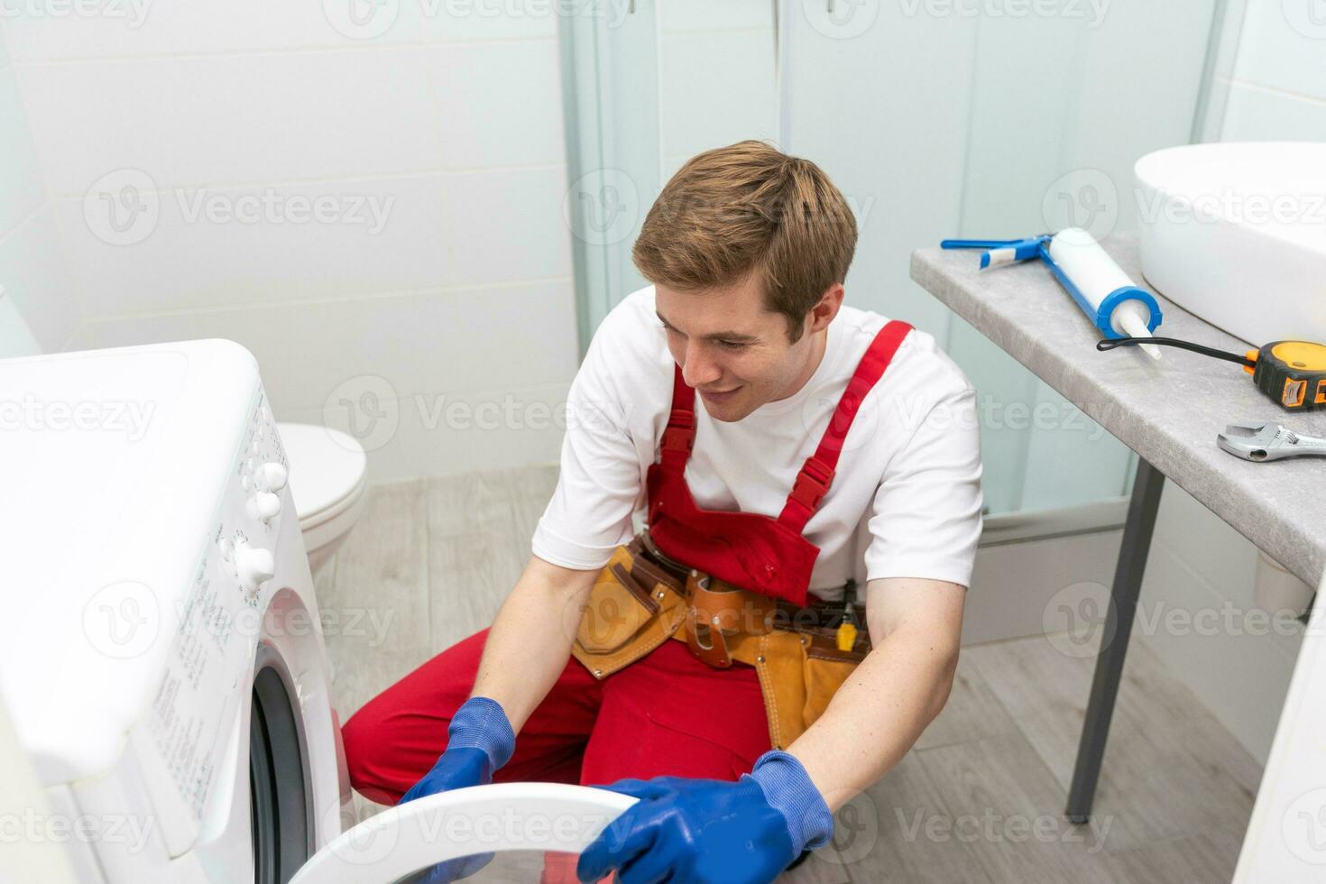 Plumber with clipboard near washing machine photo