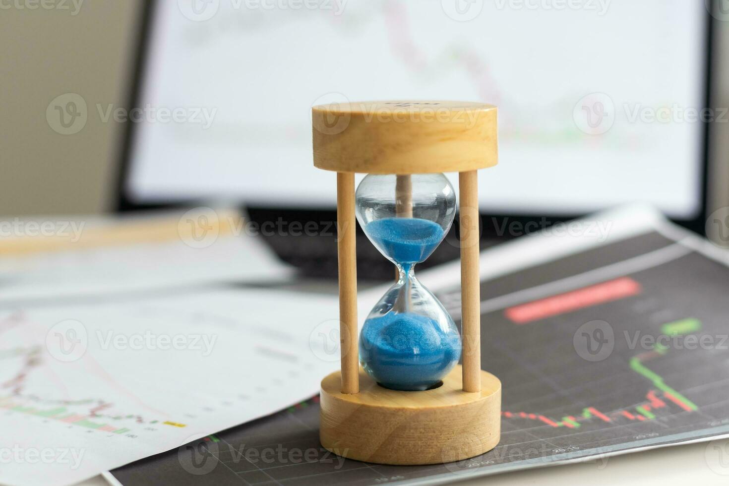 Best time for investment. Hourglass, financial charts and calculator. photo