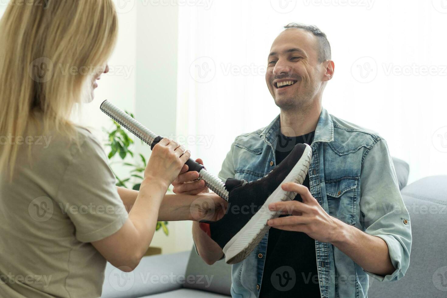 Legs of disable man in the robotic rehabilitation clinic. Doctor helping him. photo