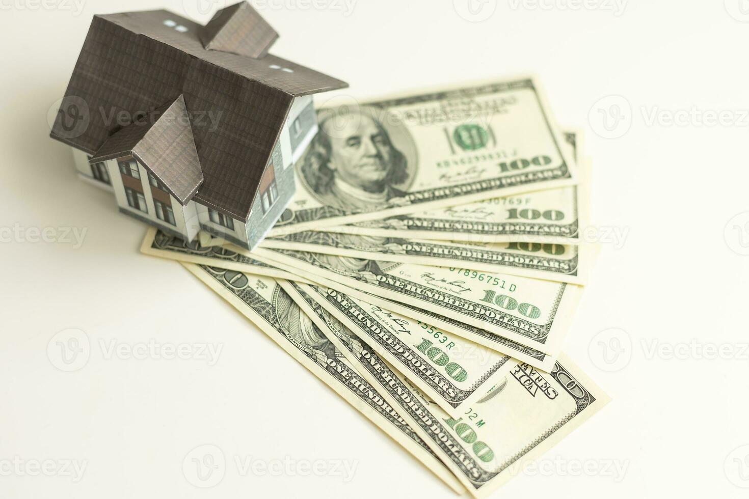 Money dollar and The model of a wooden house. Concept Having a house or buying a home or home loan. photo