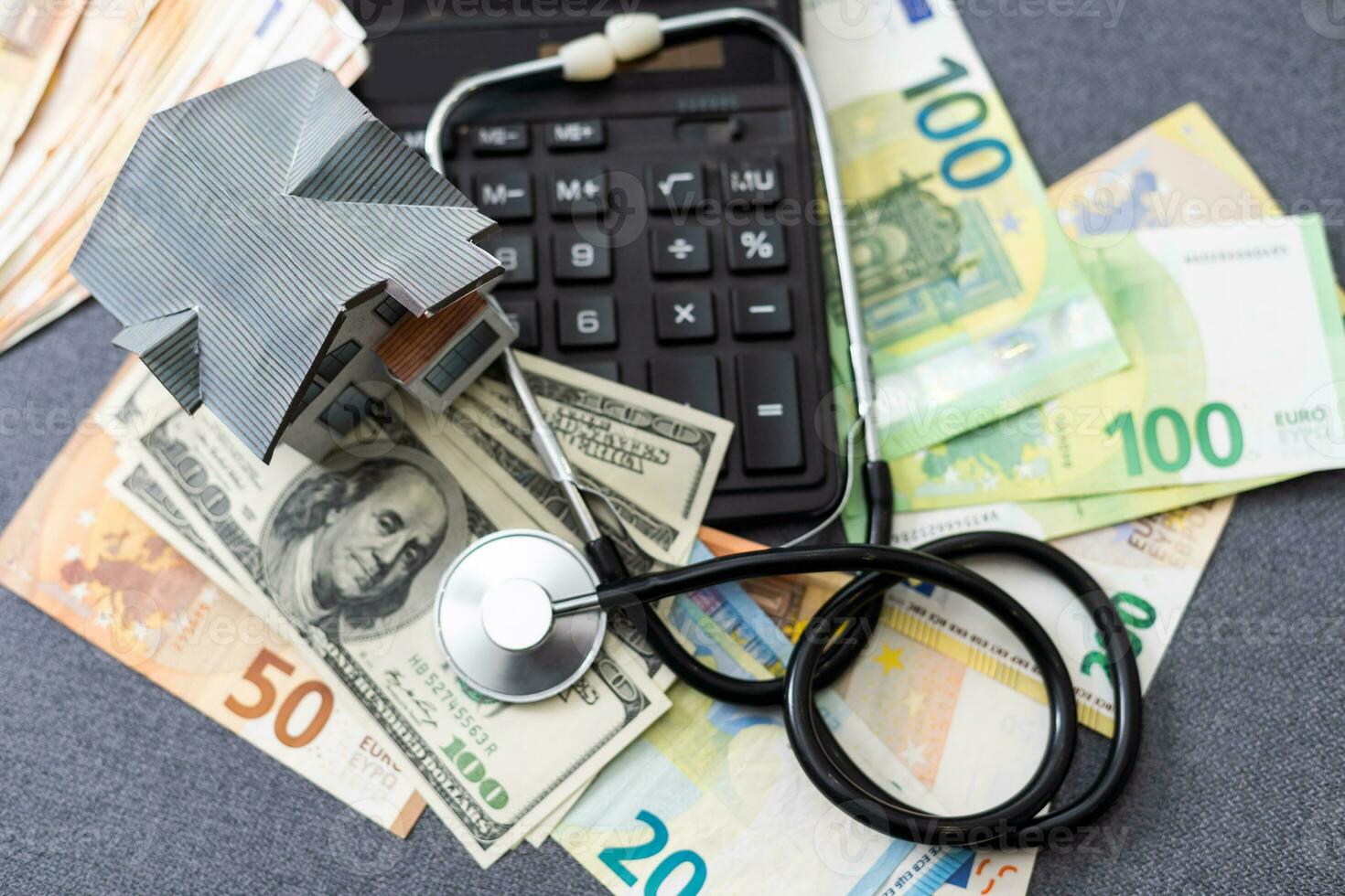 Stethoscope photo on money bank notes. Medical stethoscope is laying on money bank notes. Dollar and Euro banknotes as background for doctor gadget. Financial health concept. Expensive medicine.