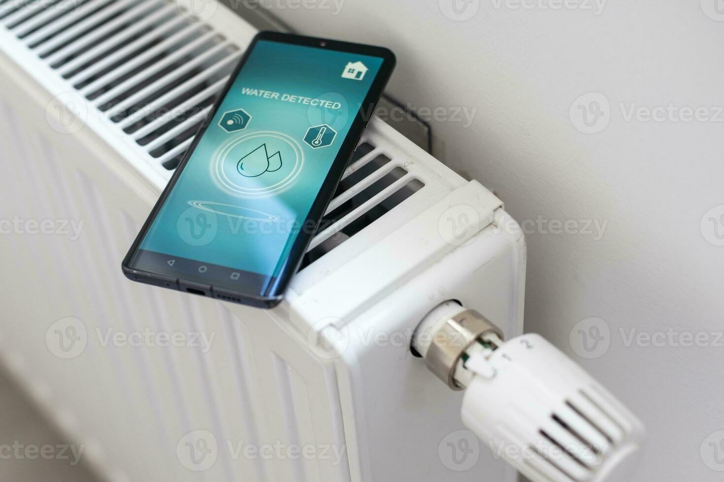 Smartphone with launched application for air temperature adjustment opposite the radiator. Health microclimate at home concept photo