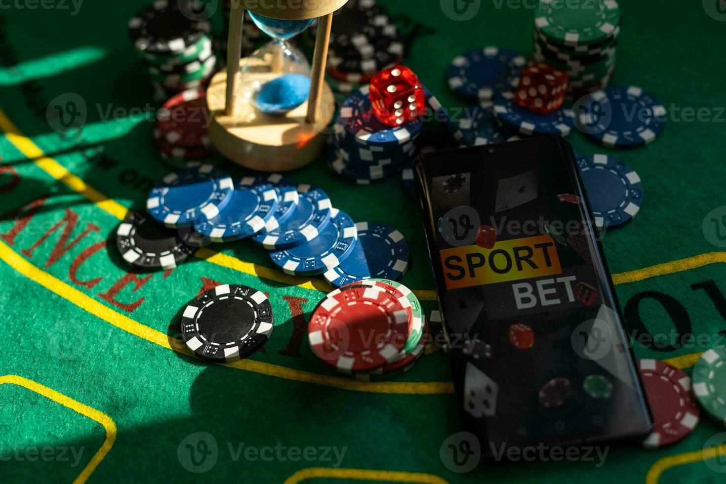 Gambling theme. Colorful playing chips in stacks on green table close up photo