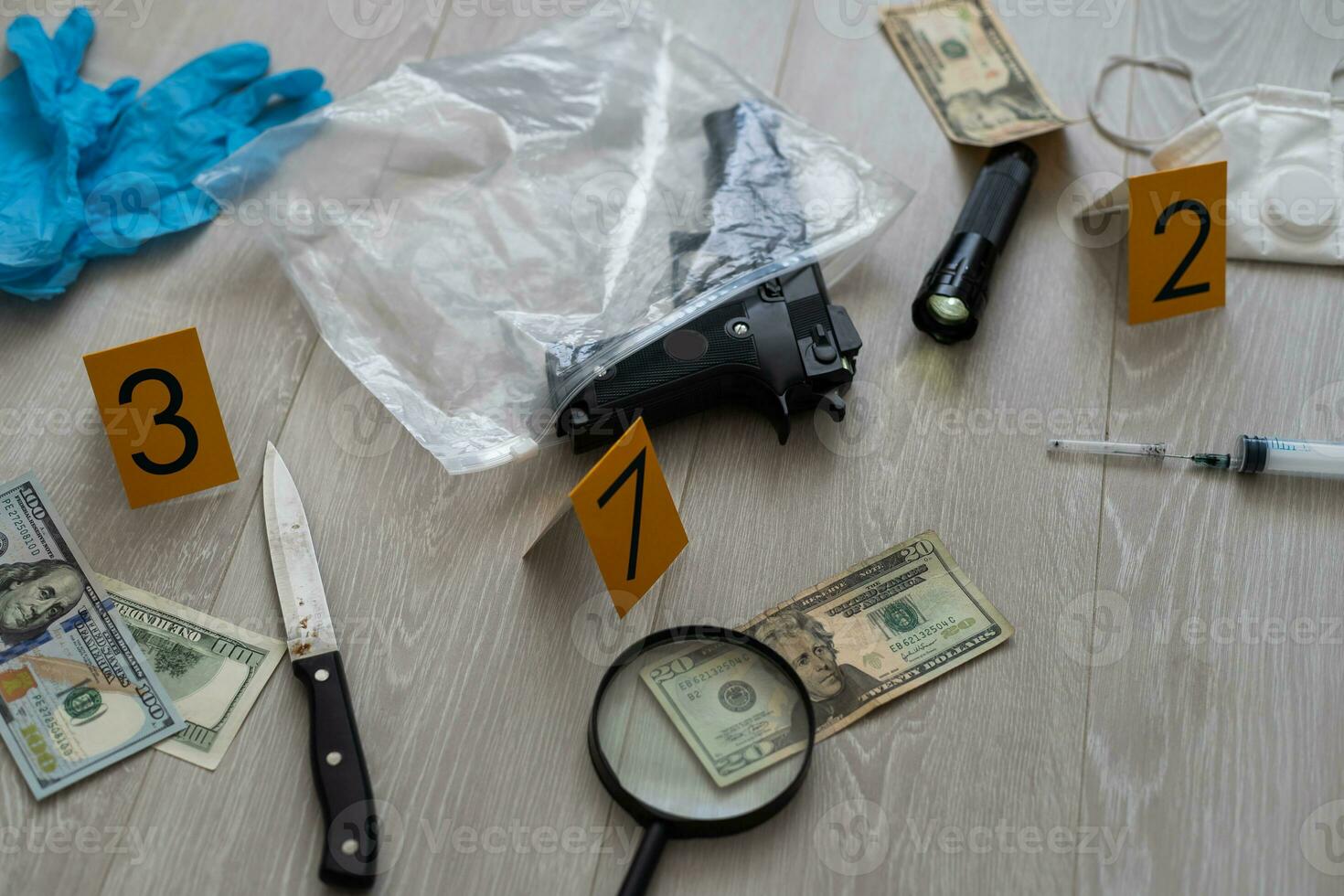 High contrast image of a crime scene with gun and markers on the floor photo