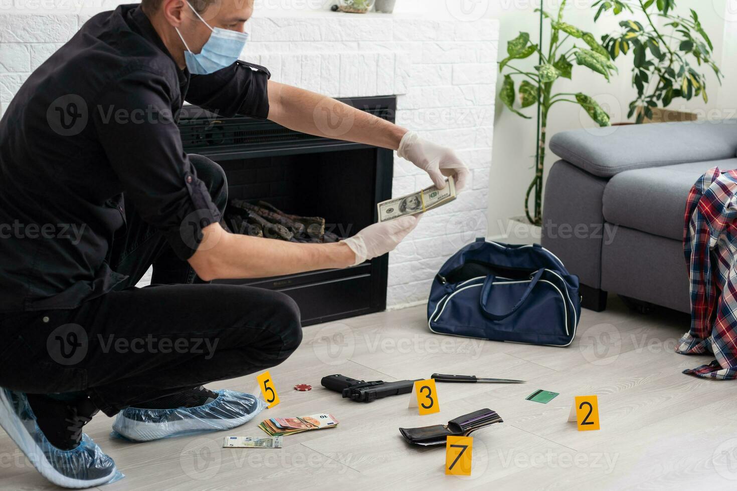 Forensics researcher photographing a blood stained knife at a murder scene photo