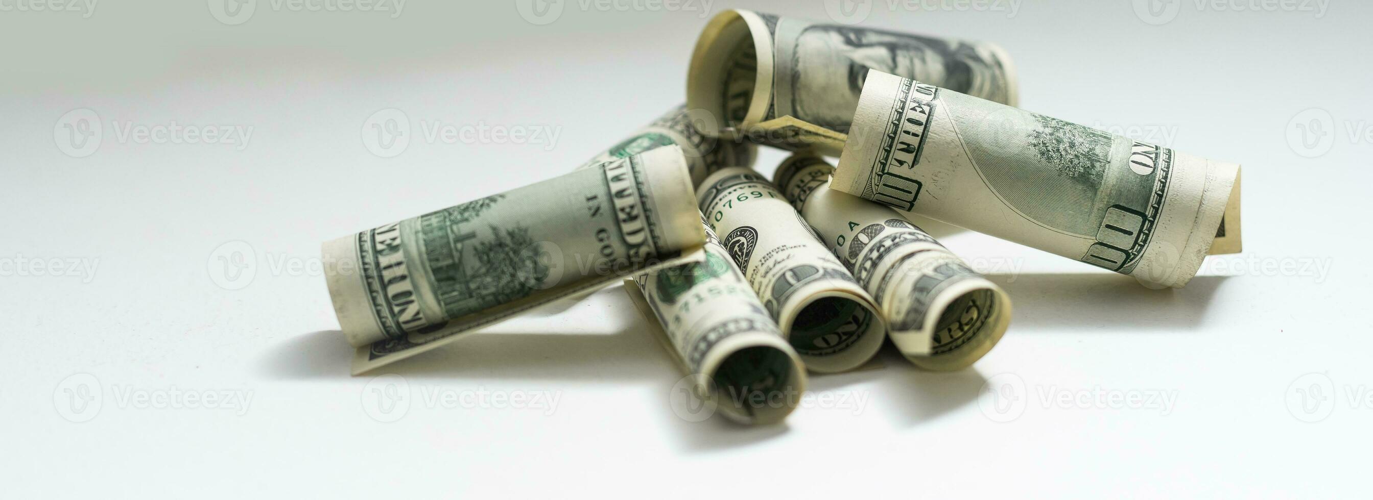 roles dollar notes in front of white background photo