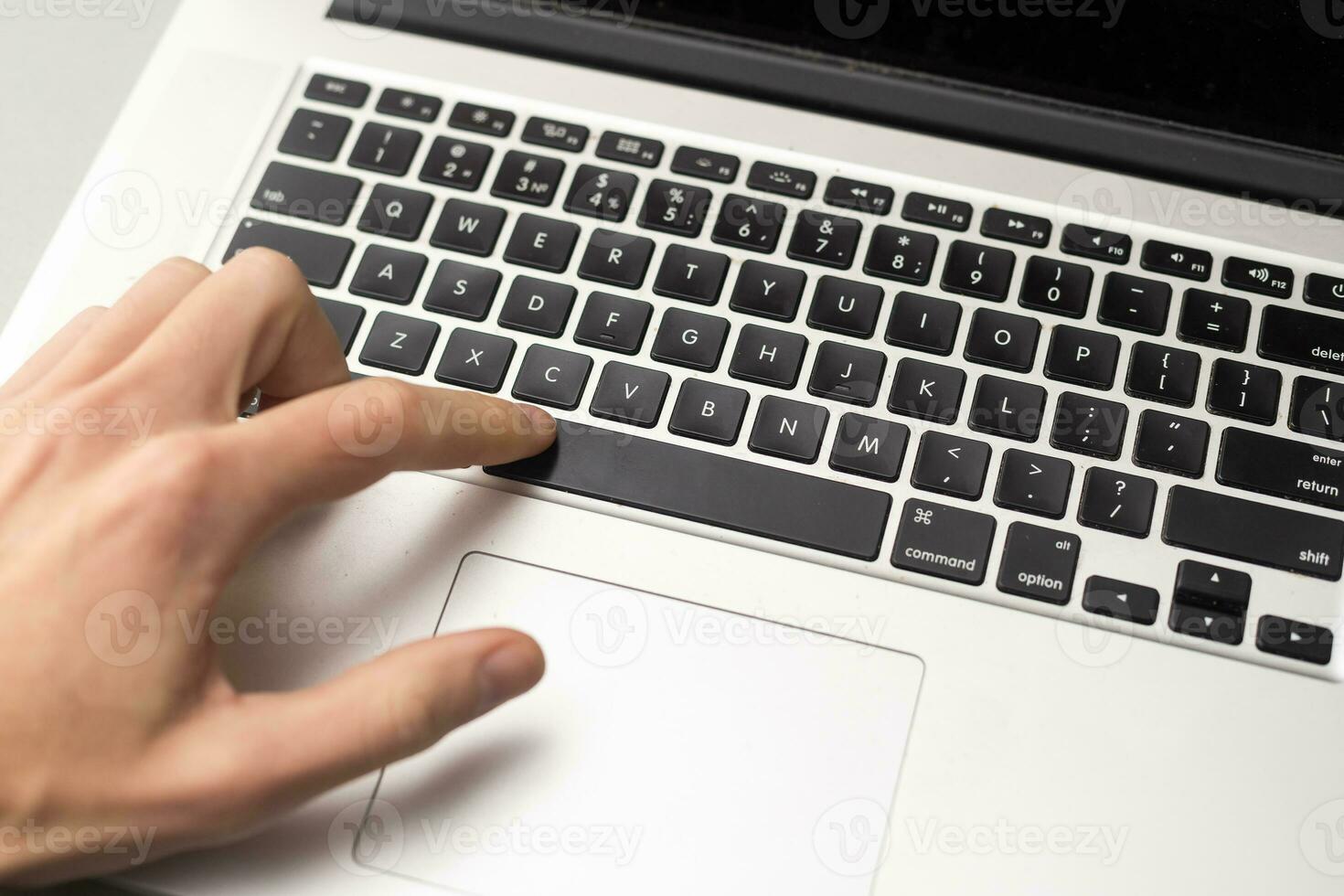 Finger pushing the button of keyboard photo