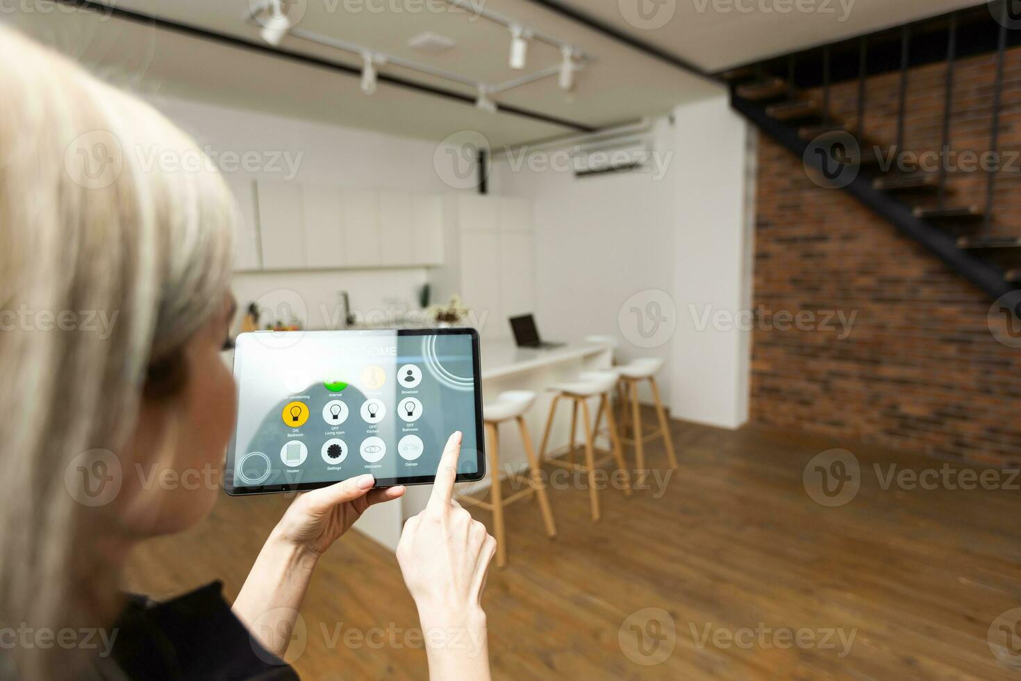 Smart home control on tablet. Interior of living room in the background photo