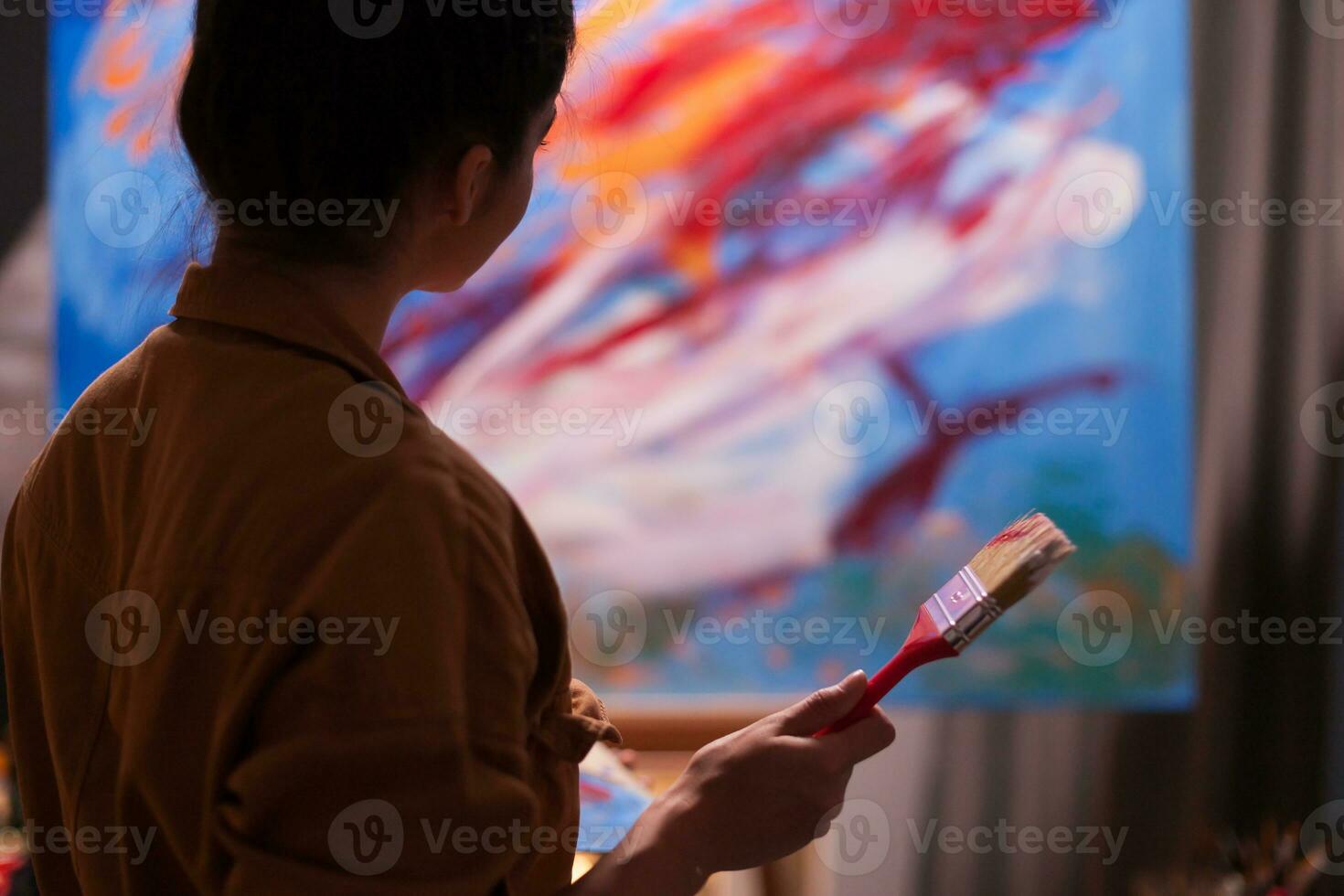 Artist admiring latest masterpiece in art workshop. Modern artwork paint on canvas, creative, contemporary and successful fine art artist drawing masterpiece photo