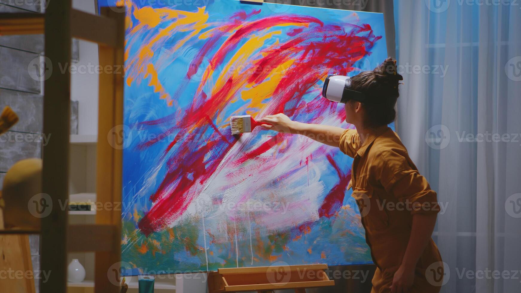 Creative artist painting using vr headset in studio. photo