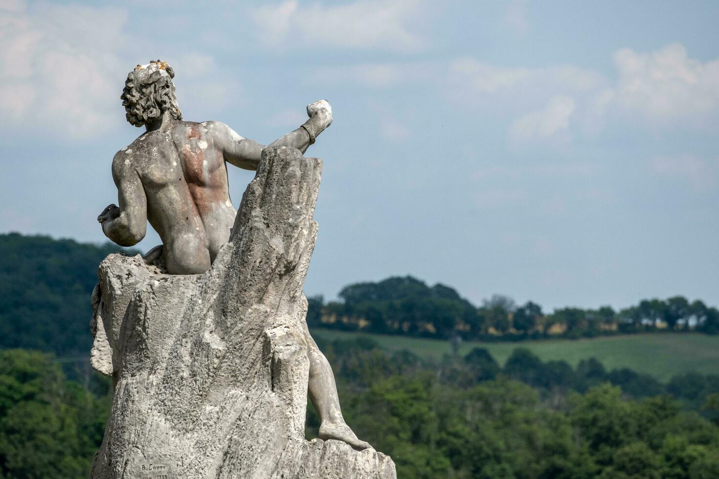 stone  statuein the sun with blue sky photo